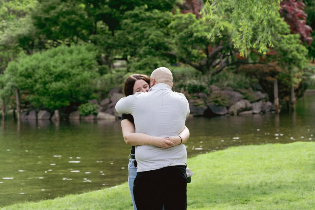 surprise proposal at the Boston Public Garden shows a couple hugging