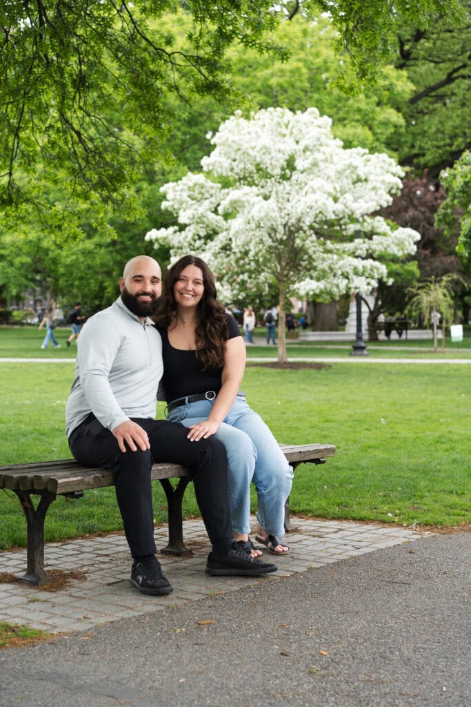 surprise proposal at the Boston Public Garden shows a couple sitting on a bench